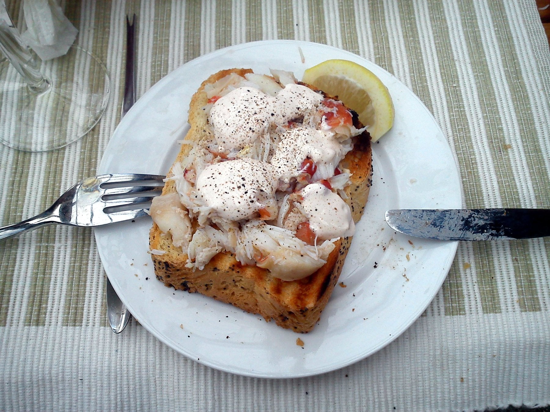 Picked crab meat piled on toasted bread with lemon