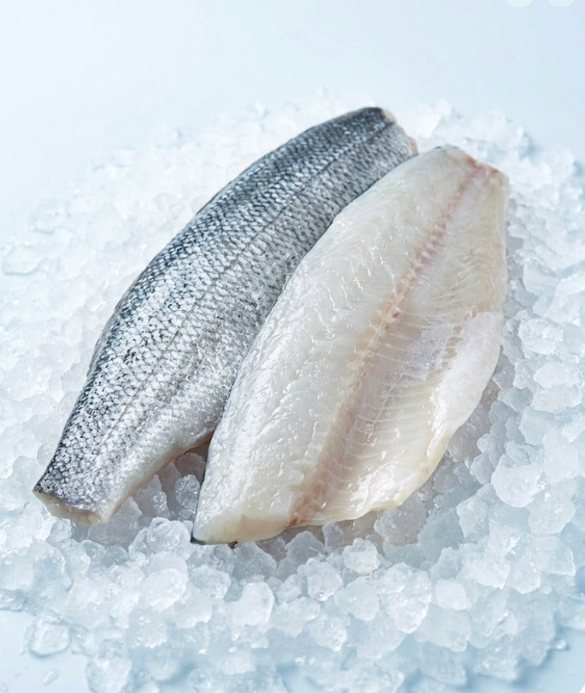 A pair of sea bass fillets, pin-boned, on crushed ice