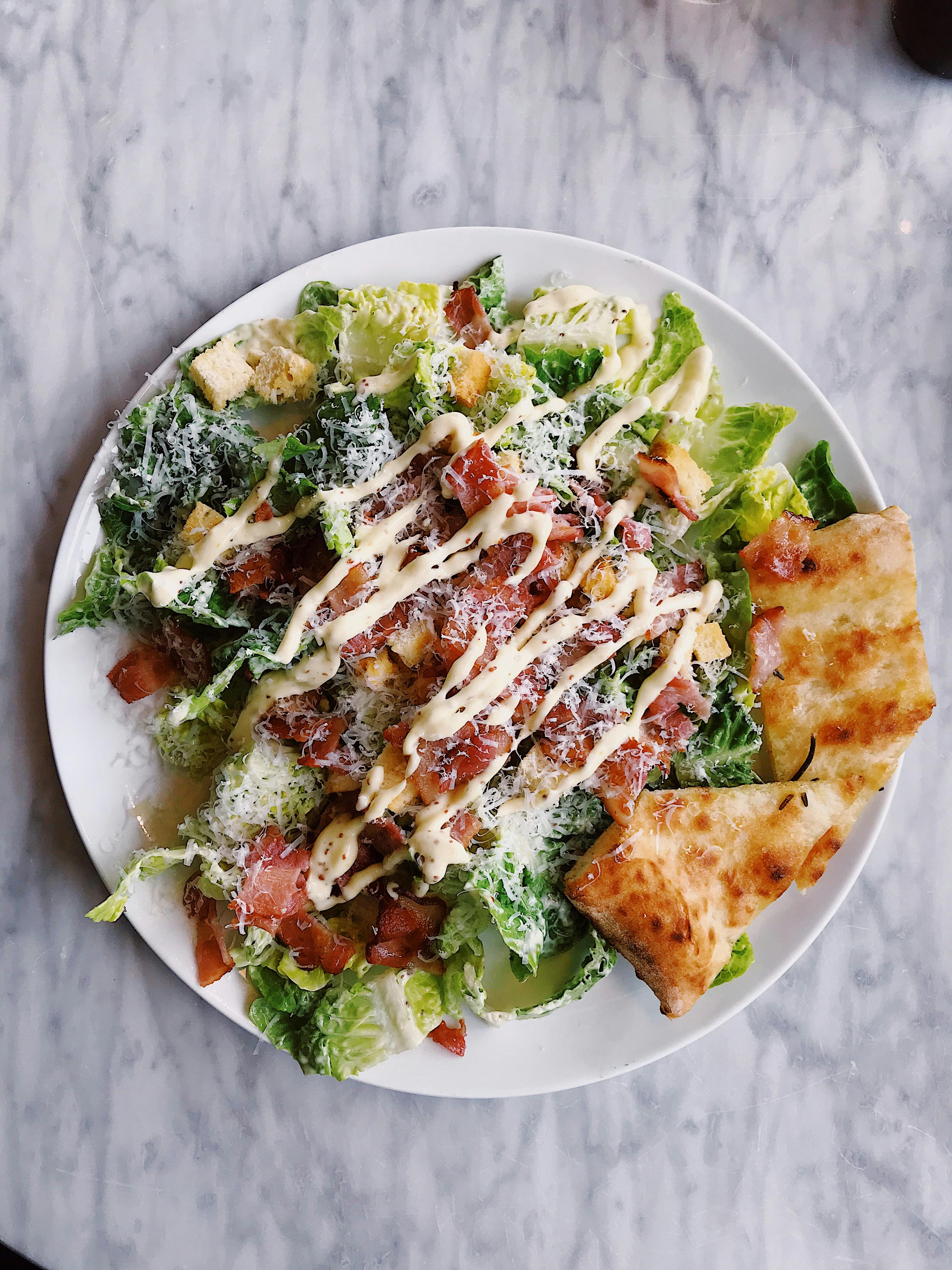 Caesar-style salad with bacon, croutons and grated cheese